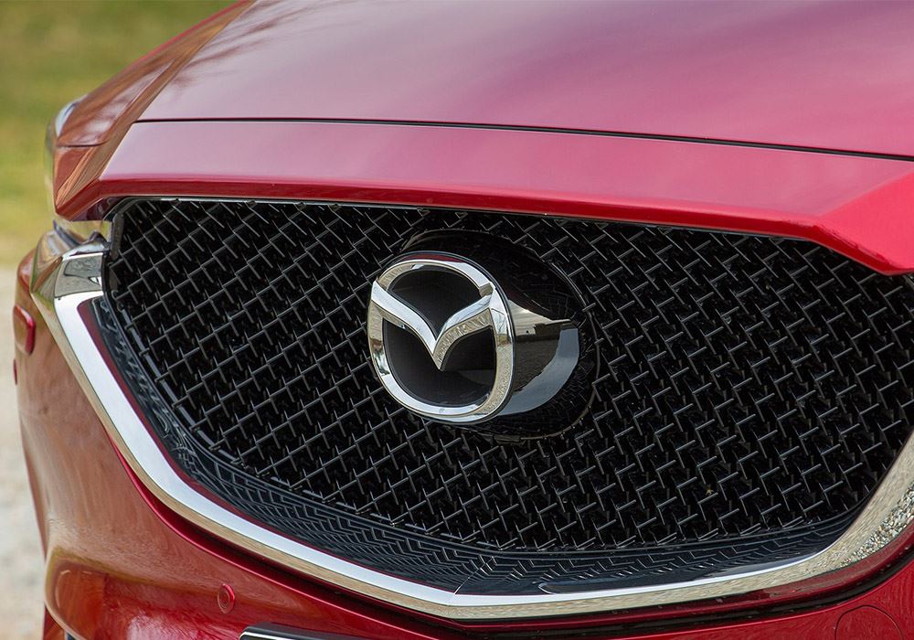 Front grille of car showing Mazda logo